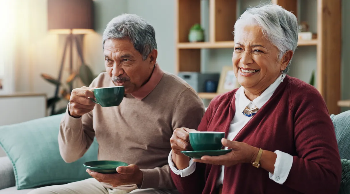 Happy senior couple drinking Organo coffee for vitality and health